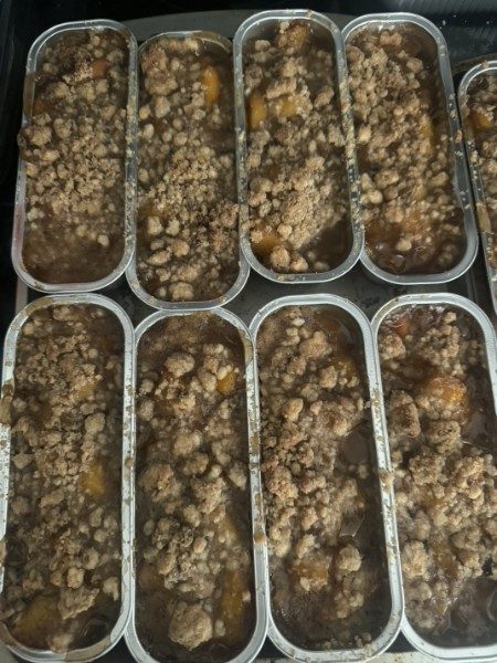 Peach cobblers with crumb topping in individual pans